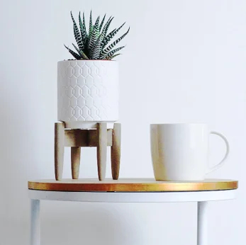 Side table with coffee cup and plant